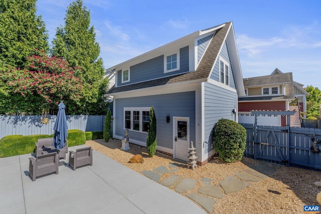 rear view of house featuring roof with shingles, a patio, an outdoor living space, and fence