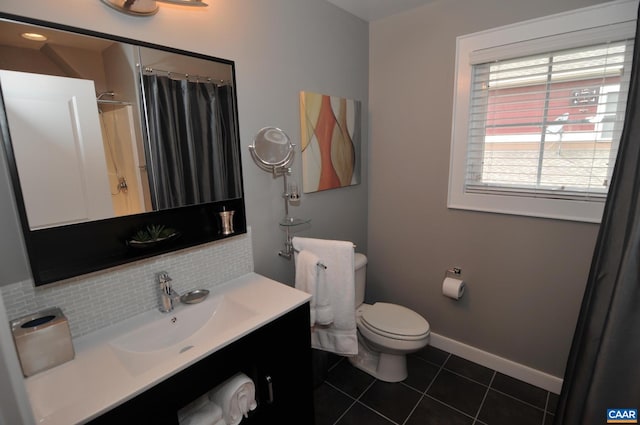 bathroom with tasteful backsplash, toilet, vanity, tile patterned flooring, and baseboards