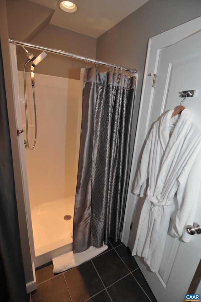 full bathroom featuring a stall shower and tile patterned floors