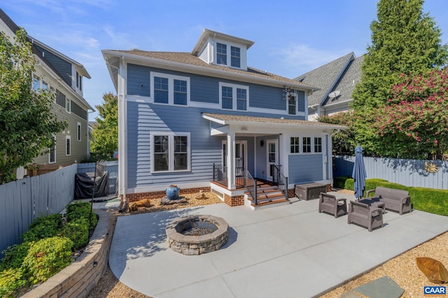 back of house with an outdoor living space with a fire pit, a patio area, and a fenced backyard