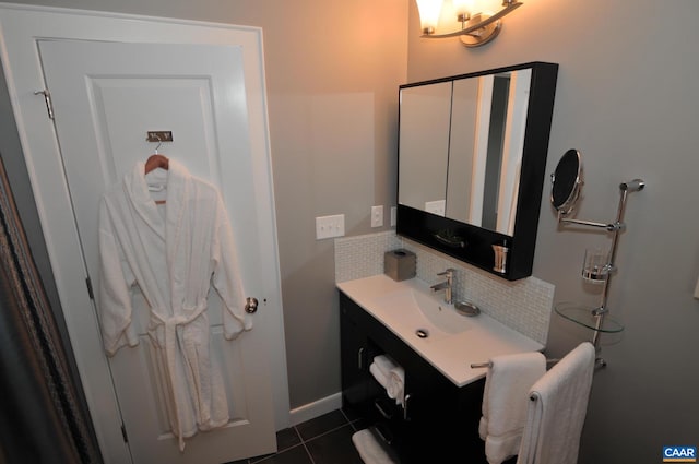 bathroom with vanity, baseboards, and tile patterned floors