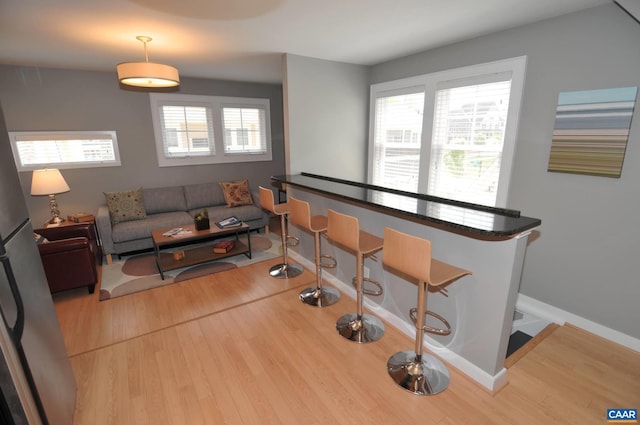 living area with wood finished floors and baseboards