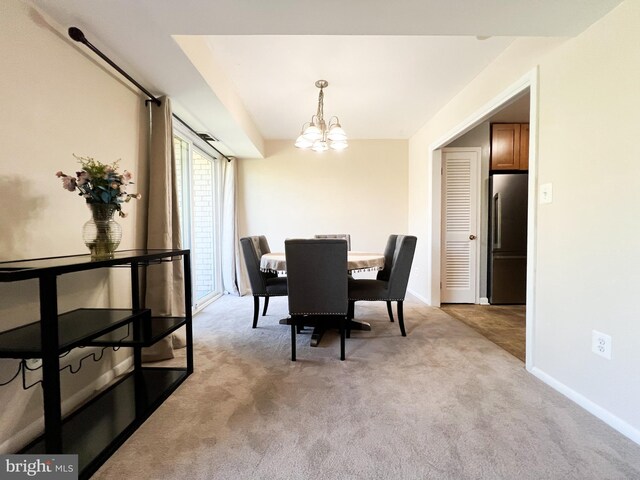 5572 Burnside Dr Unit 5572-3, Rockville, MD 20853 - dining area with an inviting chandelier, baseboards, and light colored carpet