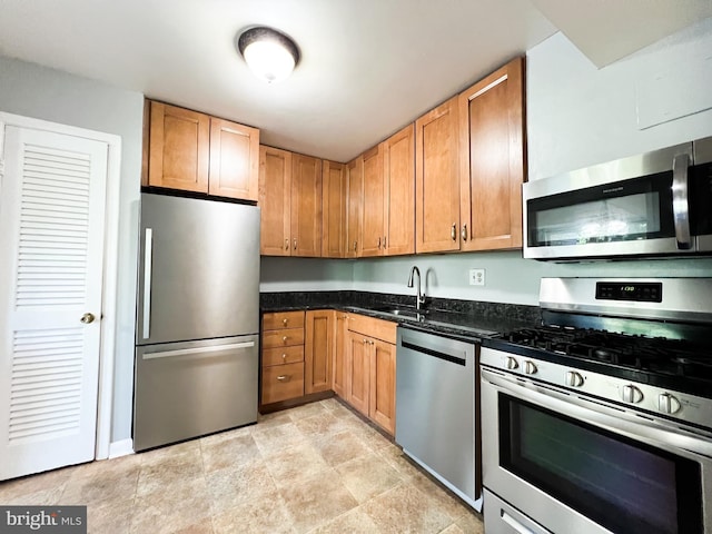 5572 Burnside Dr Unit 5572-3, Rockville, MD 20853 - kitchen with dark stone counters, a sink, and appliances with stainless steel finishes