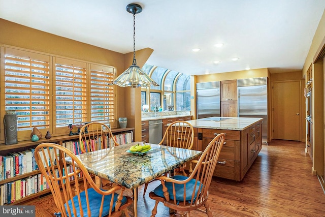 dining area with recessed lighting and wood finished floors