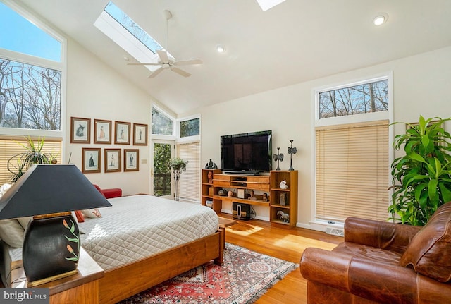 bedroom featuring ceiling fan, high vaulted ceiling, light wood-style flooring, recessed lighting, and a skylight