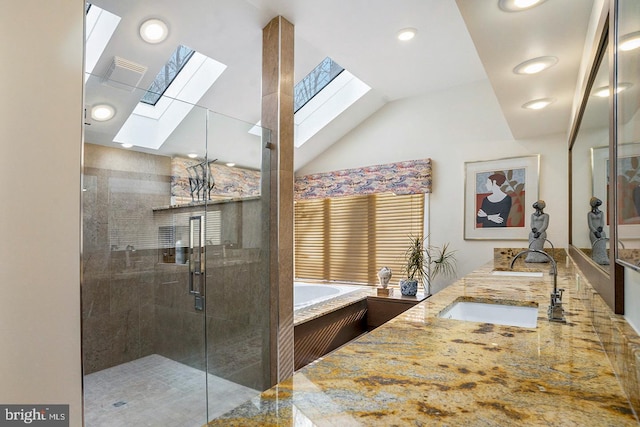 full bathroom with double vanity, lofted ceiling with skylight, a stall shower, a sink, and a bath