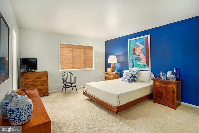 carpeted bedroom featuring baseboards