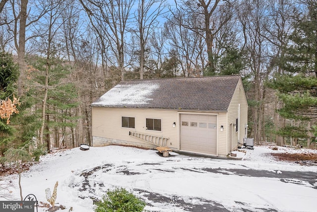 exterior space with roof with shingles and central air condition unit