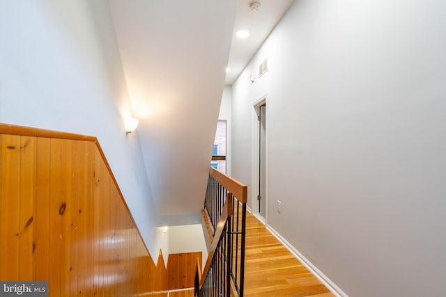 stairs with baseboards, visible vents, wood finished floors, and recessed lighting