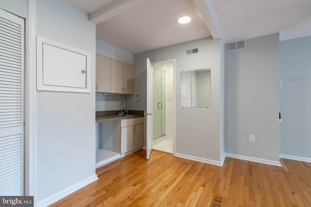 kitchen with baseboards, visible vents, and light wood-style floors