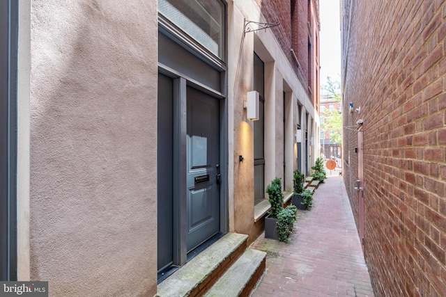 doorway to property with stucco siding