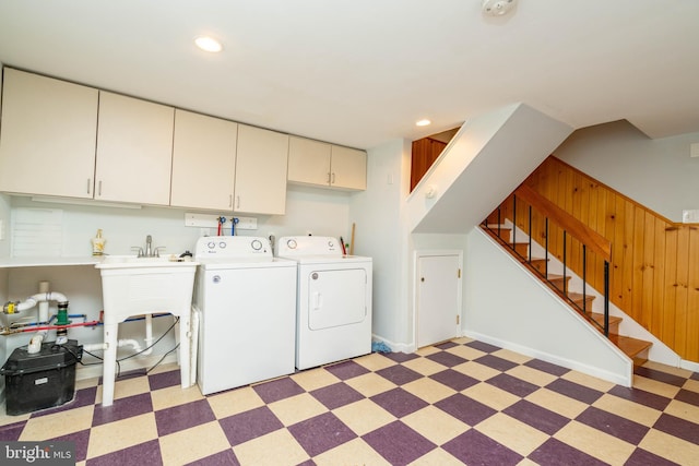 laundry area featuring light floors, recessed lighting, cabinet space, independent washer and dryer, and baseboards