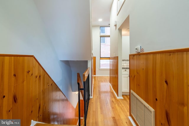 hallway featuring visible vents and light wood-style floors