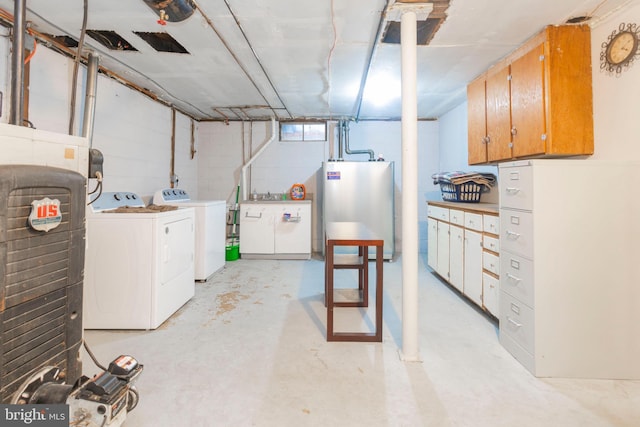 basement featuring gas water heater and separate washer and dryer