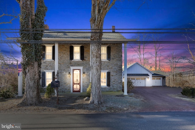 view of front of home with a garage and stone siding