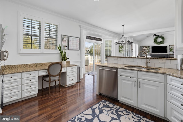 kitchen with dark wood-type flooring, dishwasher, built in desk, white cabinetry, and a sink