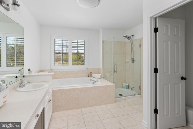 full bath featuring a wealth of natural light, a shower stall, vanity, and a garden tub