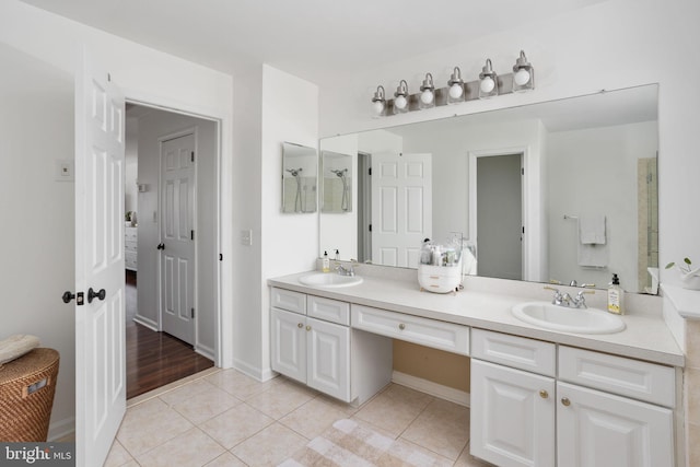 bathroom featuring a sink, walk in shower, double vanity, and tile patterned floors