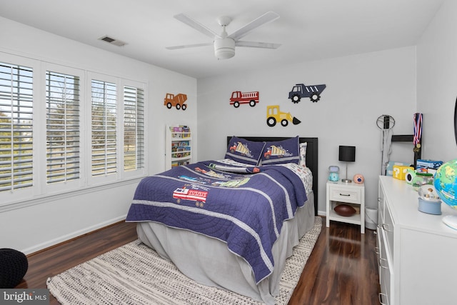 bedroom with dark wood finished floors, baseboards, visible vents, and ceiling fan