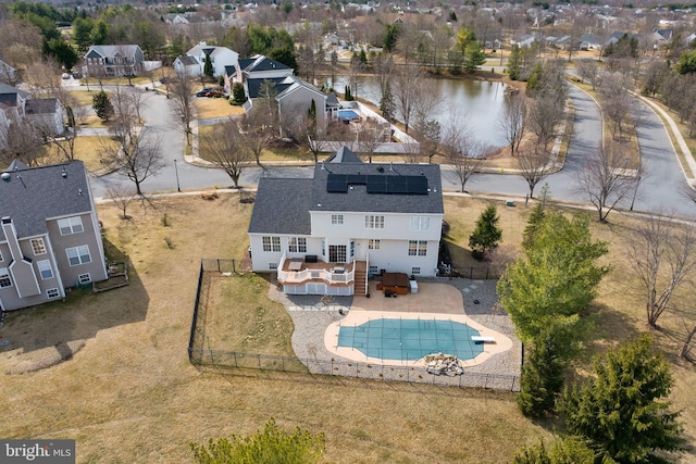 drone / aerial view with a residential view and a water view