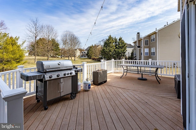 wooden deck featuring a grill