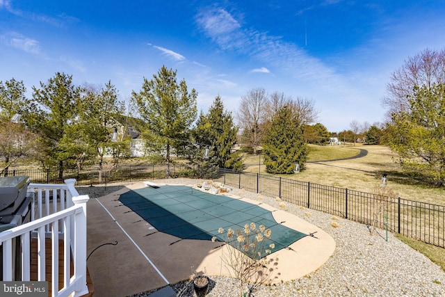 view of swimming pool with a fenced in pool, a patio, a lawn, and a fenced backyard