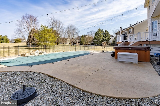 view of pool featuring a patio area, a fenced in pool, a hot tub, and fence