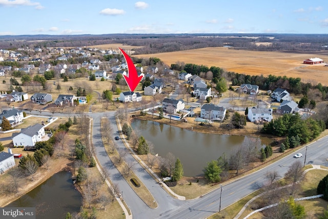 birds eye view of property featuring a residential view and a water view