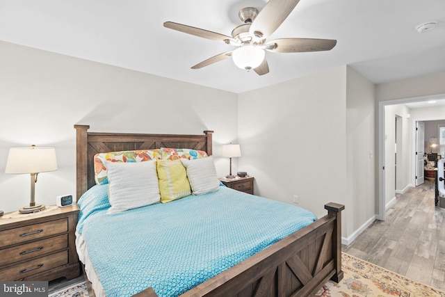 bedroom featuring a ceiling fan, light wood-type flooring, and baseboards