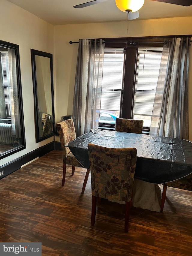 dining room featuring wood finished floors, a ceiling fan, and baseboards