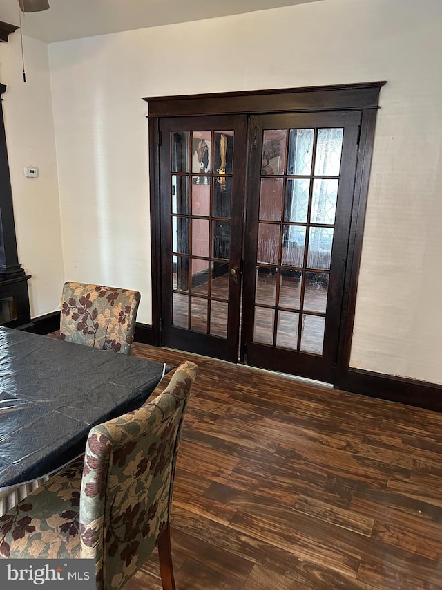 dining space with french doors, wood finished floors, and baseboards