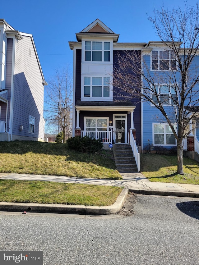 view of front of property with a porch and a front yard