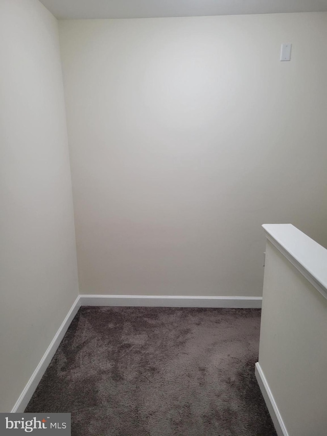 empty room with carpet and baseboards