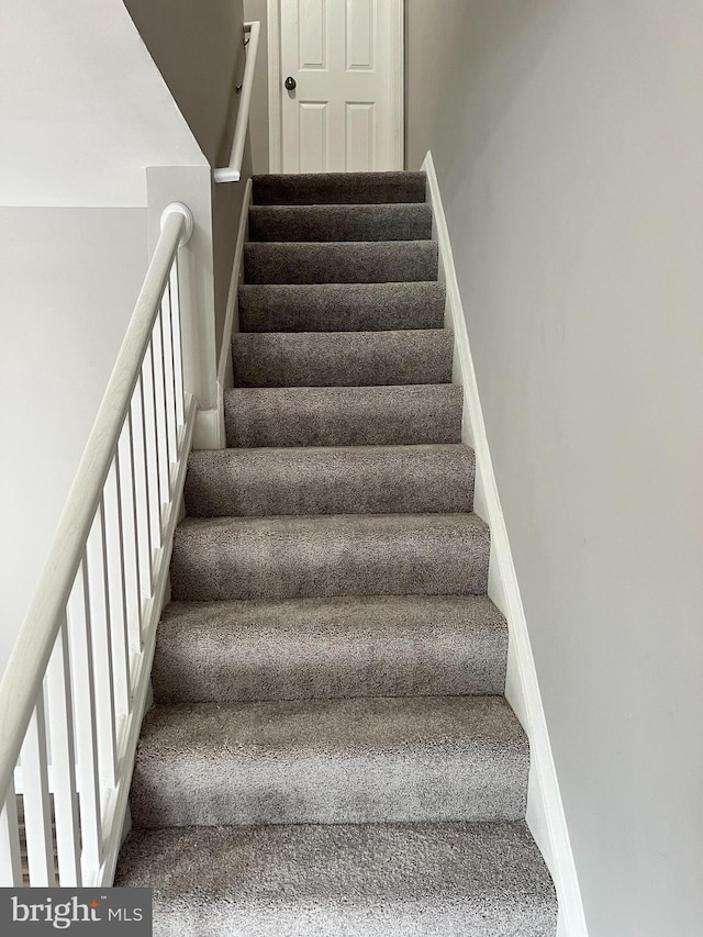 stairs featuring baseboards