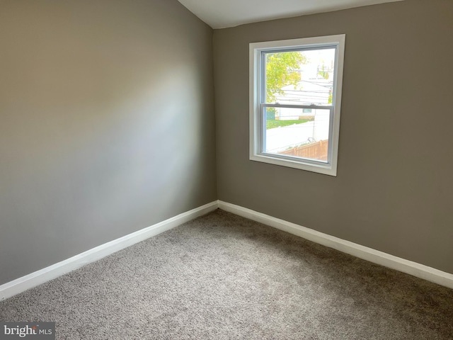 spare room with carpet and baseboards