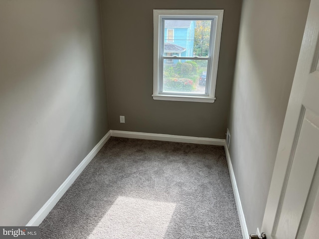 empty room with carpet flooring and baseboards