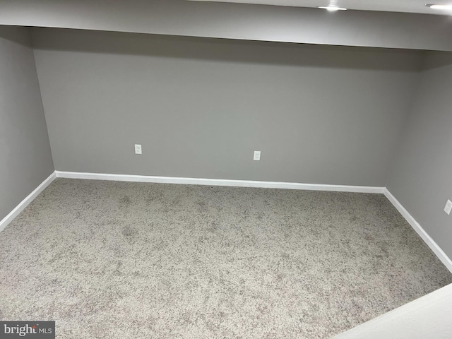 below grade area featuring carpet floors and baseboards