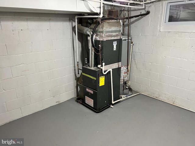 utility room featuring heating unit and water heater