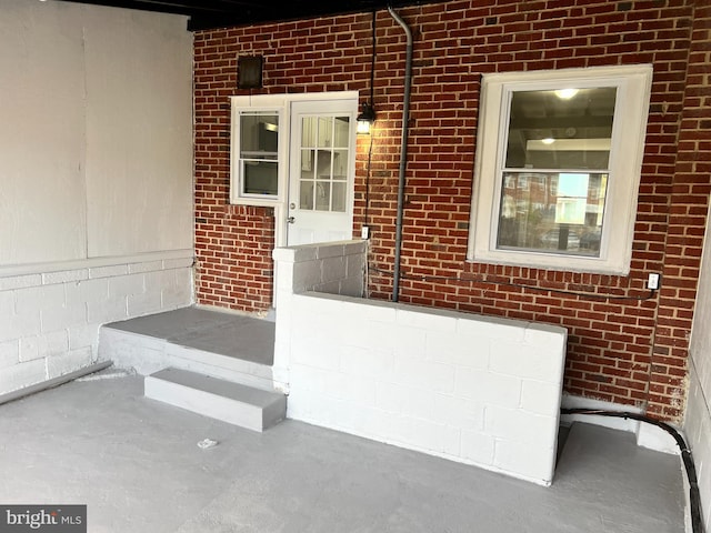 entrance to property with brick siding