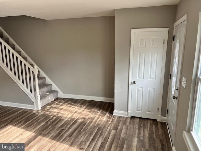 entryway featuring stairway, wood finished floors, and baseboards