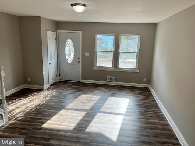 entryway with visible vents, dark wood finished floors, and baseboards