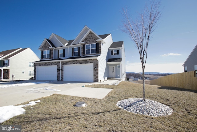 view of front of property featuring an attached garage, stone siding, fence, and concrete driveway