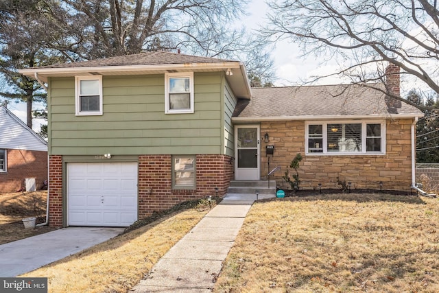 split level home featuring roof with shingles, brick siding, a chimney, an attached garage, and stone siding