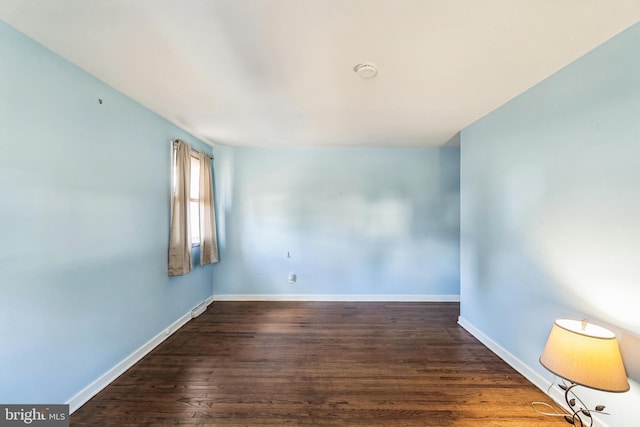 empty room with wood finished floors and baseboards