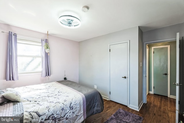 bedroom featuring wood finished floors and baseboards