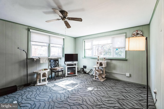 interior space with carpet floors and ceiling fan