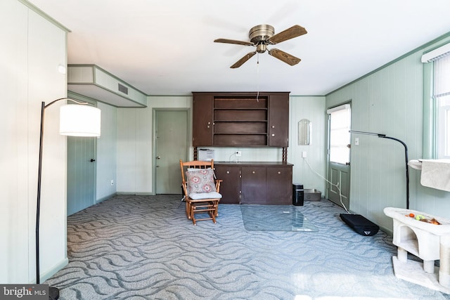 sitting room featuring carpet floors, visible vents, and ceiling fan