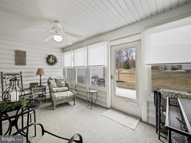 sunroom / solarium with a healthy amount of sunlight and ceiling fan