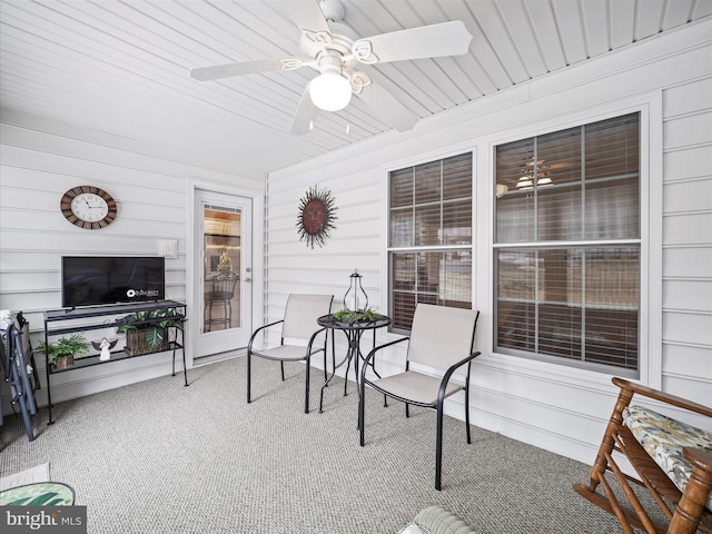 sunroom / solarium featuring ceiling fan